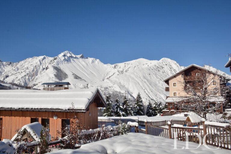 Panoramic view across snowy St Martin de Belleville towards the surrounding mountains