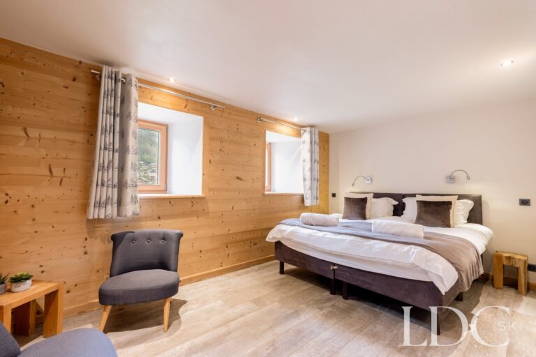 Double bedroom with timber walls at La Ferme de la Couttetaz in Morzine