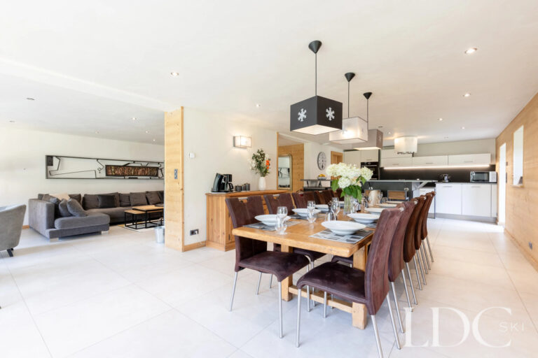 Open-plan dining area leading through to the kitchen at La Ferme de la Couttetaz