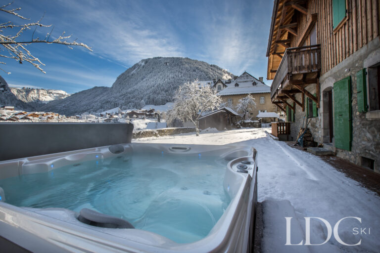 Outdoor hot tub beside the chalet with panoramic snowy mountain views in Morzine