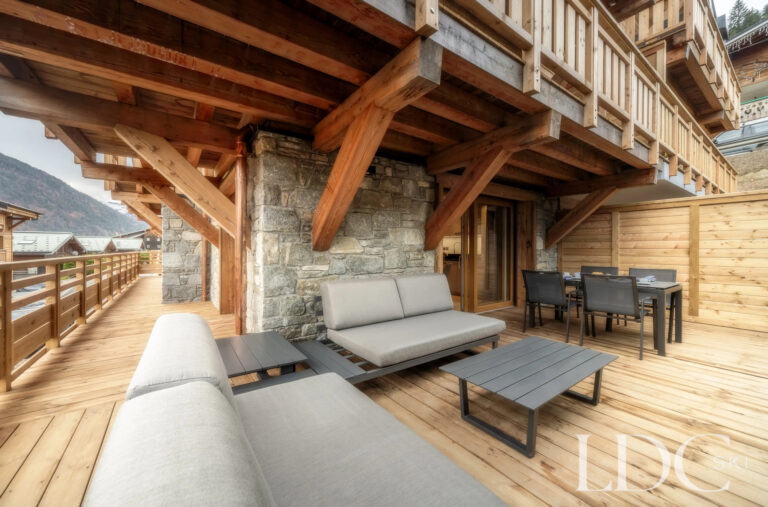 Les Deux Frères covered timber balcony with outdoor seating
