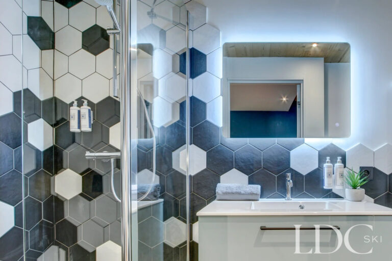 Modern bathroom with geometric monochrome tiles at Piste Bleue