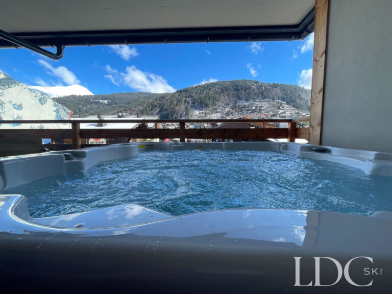 Covered outdoor hot tub with mountain views at Piste Bleue in Morzine