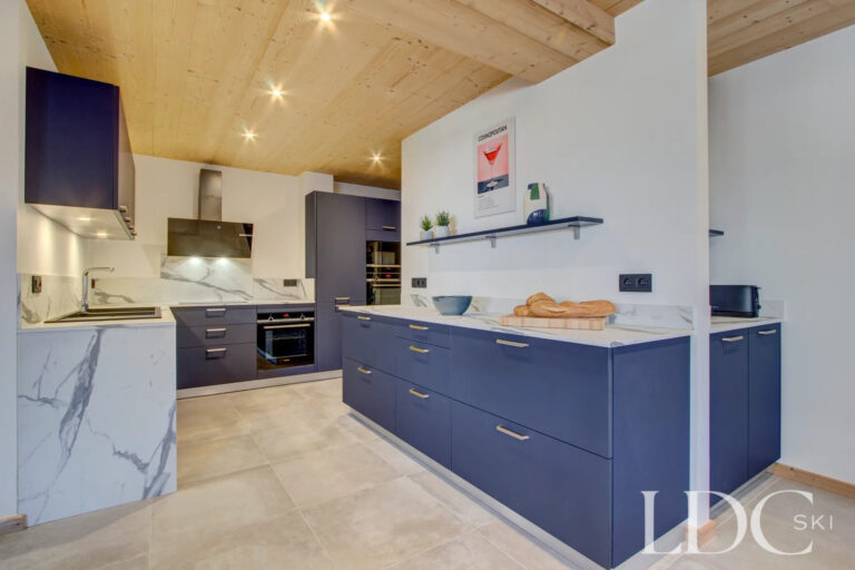 Modern open-plan kitchen with central island at Piste Bleue
