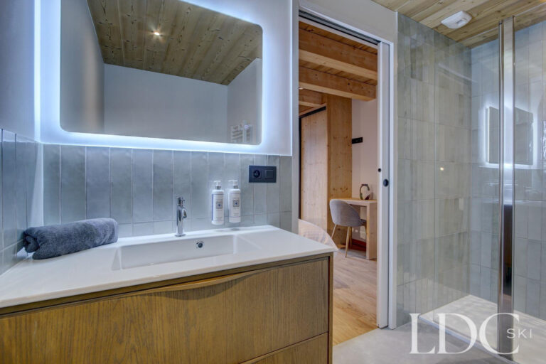 Piste Noire ensuite shower room with illuminated mirror and timber vanity