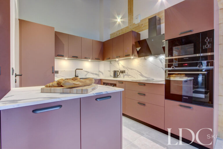 Piste Noire contemporary kitchen with pink cabinetry and integrated appliances
