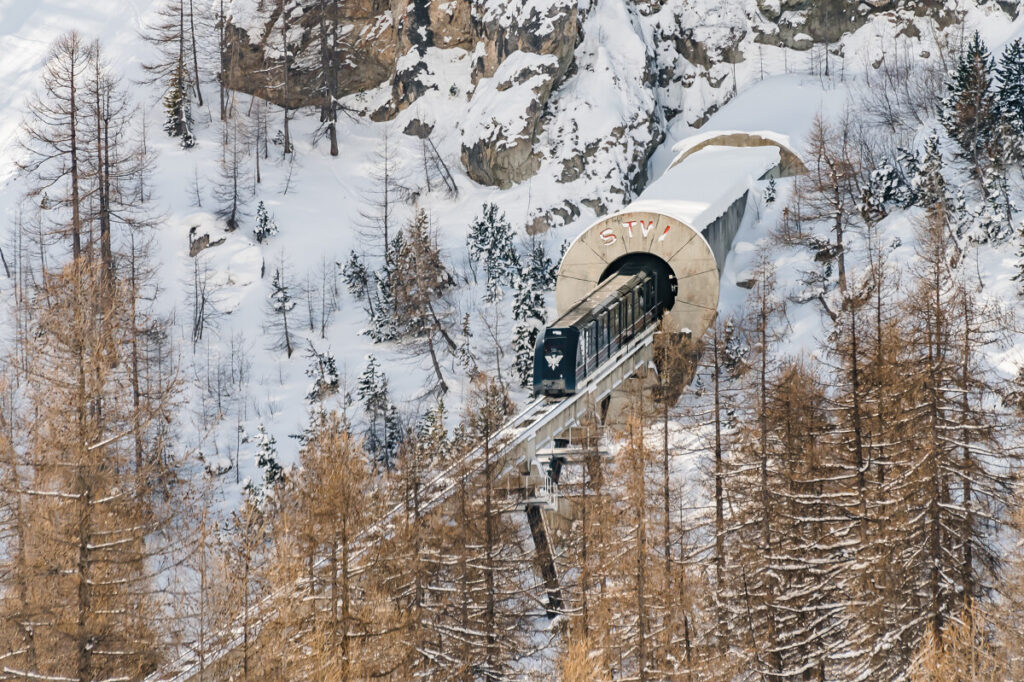 Funicular travelling through the snowy forest in Val d'Isère. © Anna Cantu