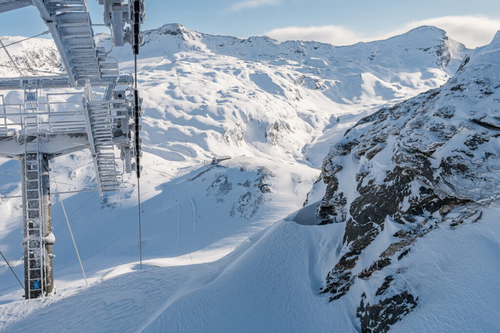 Ski lift above the snow-covered slopes and mountains of Val d'Isère. © Anna Cantu