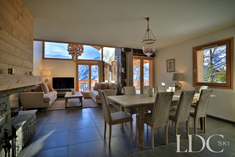 Spacious open-plan living and dining area with mountain views at Chalet Aphylla
