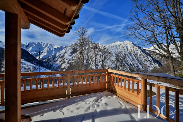 Snow-covered terrace with panoramic mountain views at Chalet Aphylla