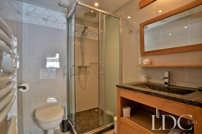 Contemporary shower room with timber vanity at Chalet Aralia