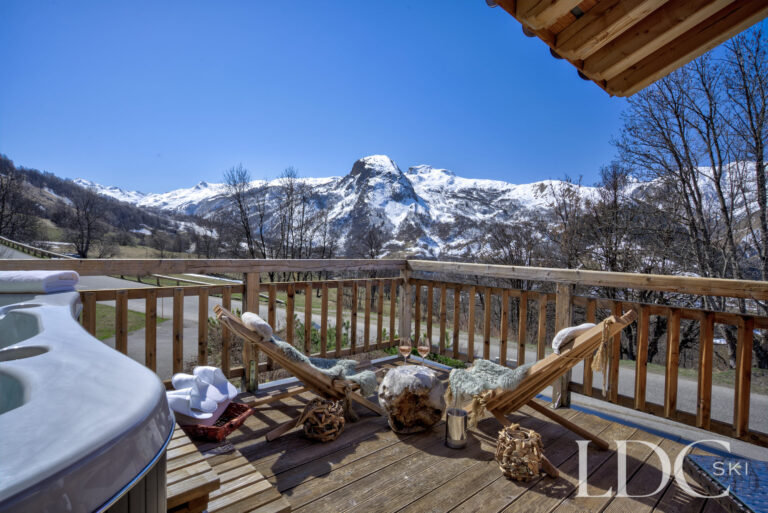 Private hot tub on the terrace overlooking the snowy mountains at Chalet Aralia