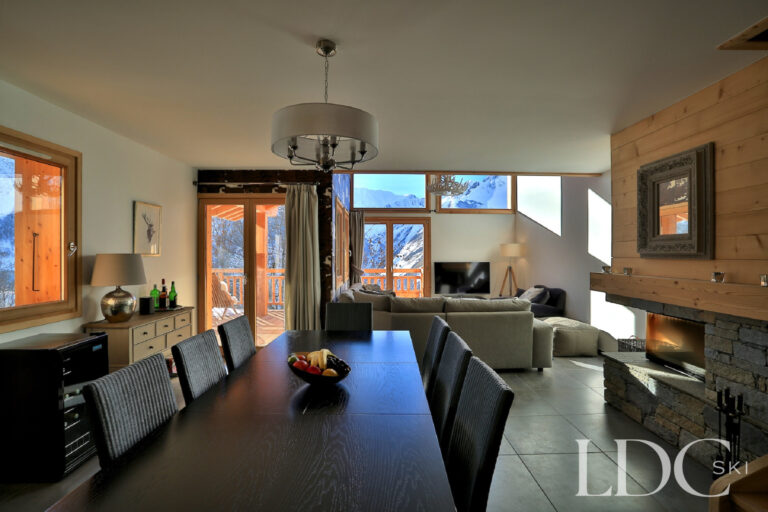 View through the open-plan dining and living space towards the mountains at Chalet Aralia