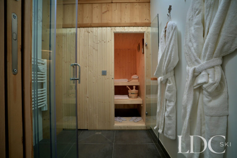 Private timber sauna with robes at Chalet Aralia