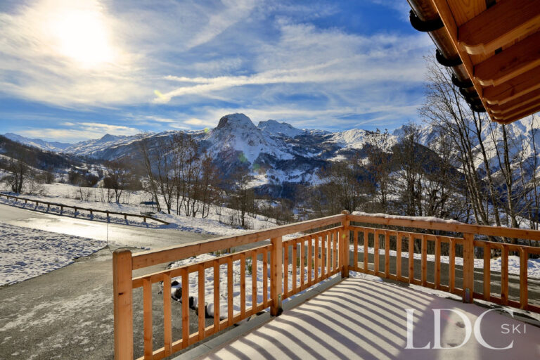 Panoramic snowy mountain view from the terrace at Chalet Aralia