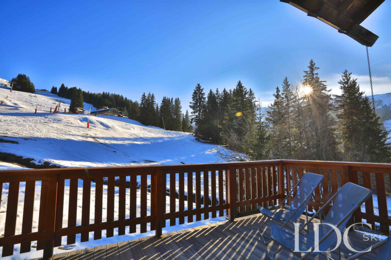 Sunny terrace overlooking the snowy slopes at Chalet Cecilia in Méribel