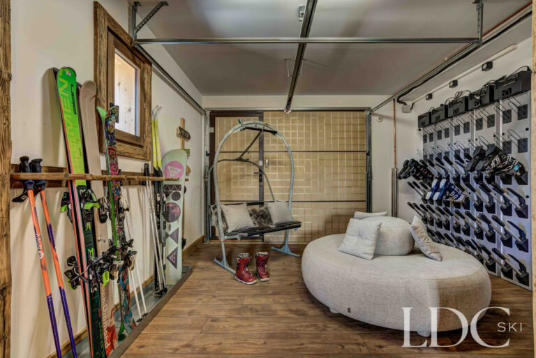 Spacious ski room with racks, equipment storage and boot warmers at Chalet Chez Bugi