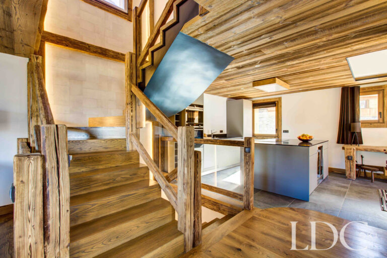 Timber staircase overlooking the contemporary kitchen at Chalet Chez Bugi