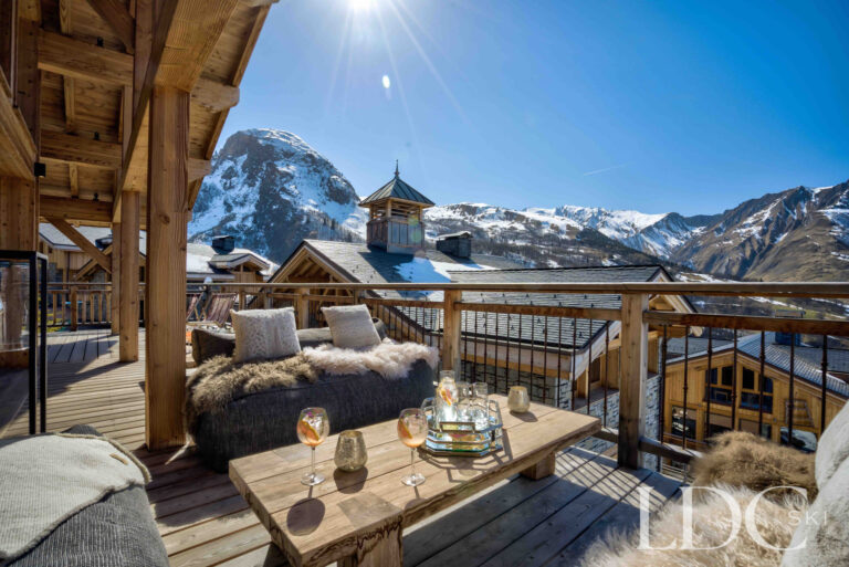 Sunny terrace with seating and spectacular mountain views at Chalet Chez Bugi