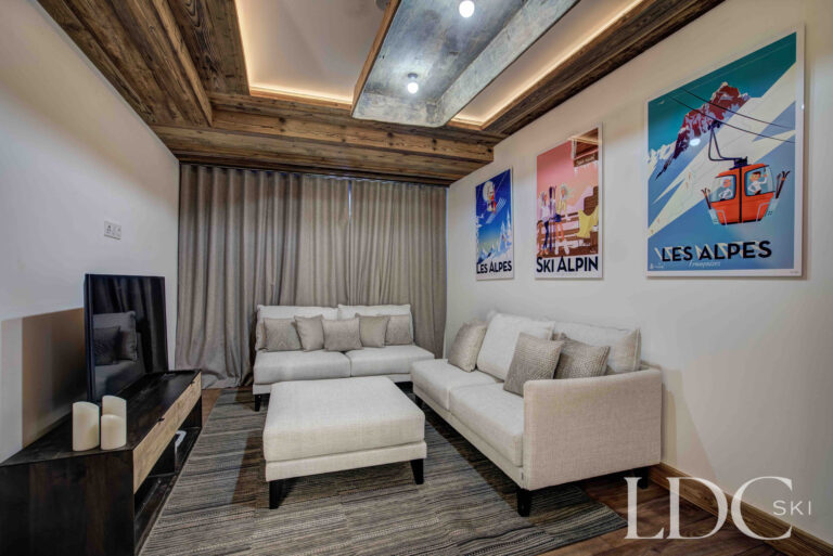 Separate TV snug with comfortable sofa seating at Chalet Chez Bugi