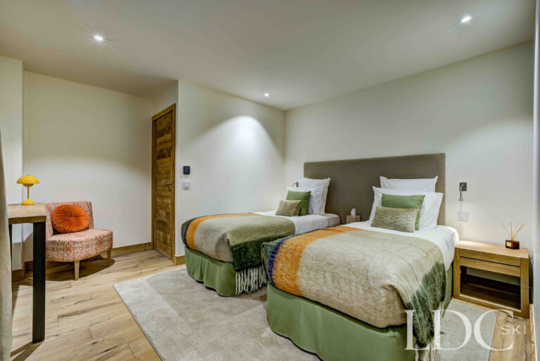 Twin bedroom with soft green furnishings at Chalet Constantia