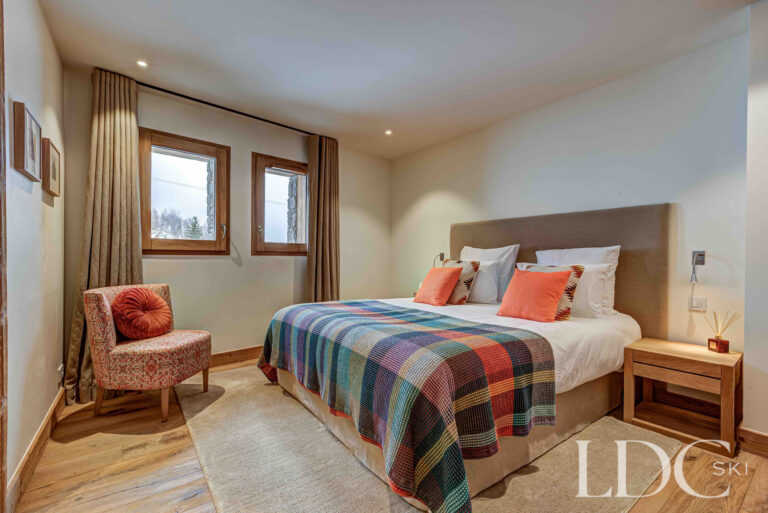 Double bedroom with colourful Alpine furnishings at Chalet Constantia