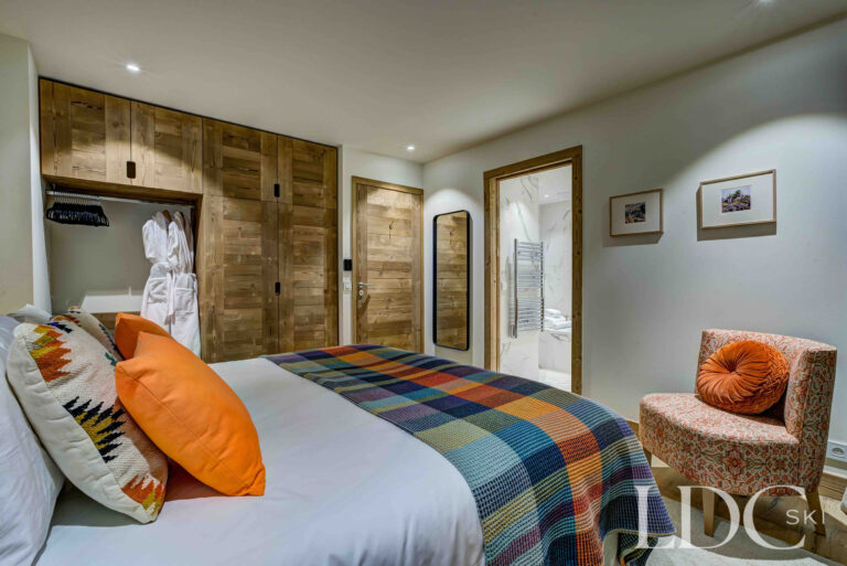 Second view of the spacious double bedroom with colourful Alpine furnishings at Chalet Constantia