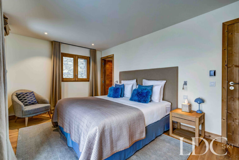 Second view of the double bedroom with balcony access and snowy mountain views at Chalet Constantia