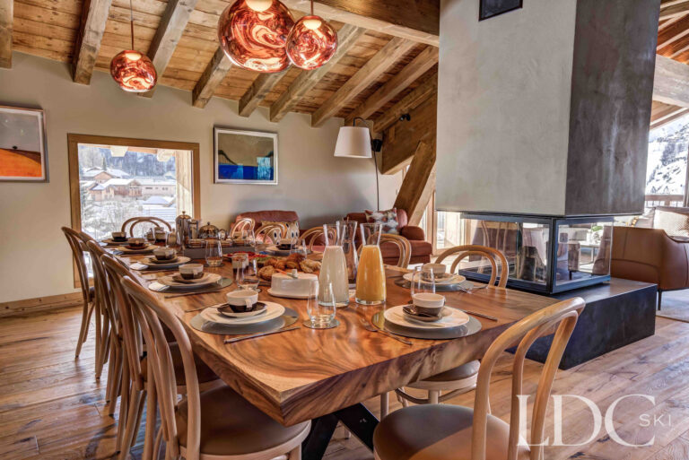 Dining table laid for breakfast in the open-plan living area at Chalet Constantia