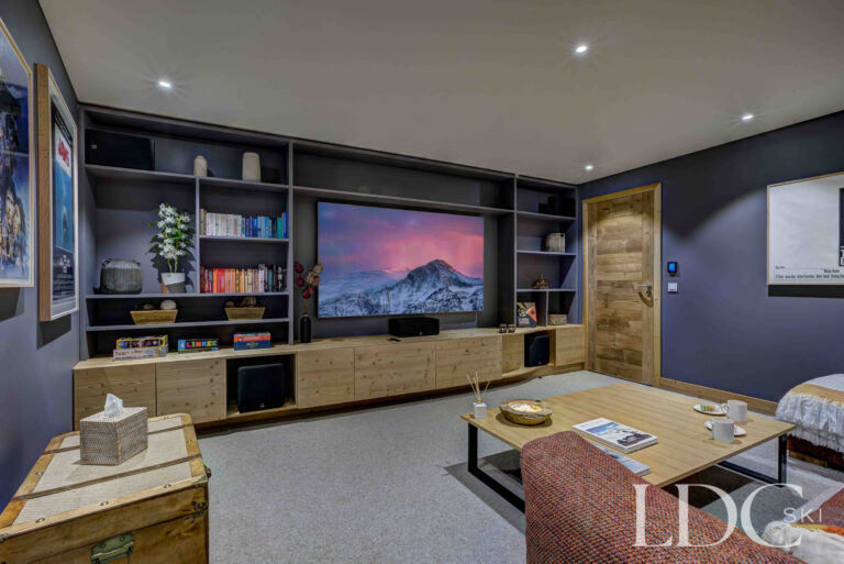 Spacious private cinema room with sofas and built-in entertainment system at Chalet Constantia
