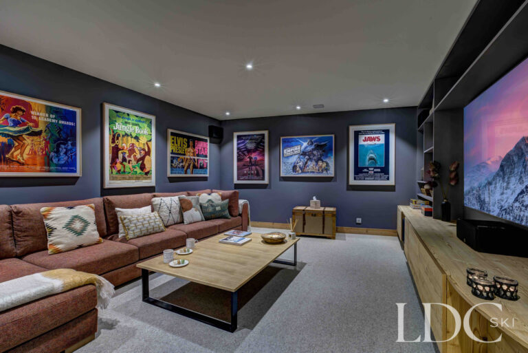 Private cinema room with large screen and comfortable tiered seating at Chalet Constantia