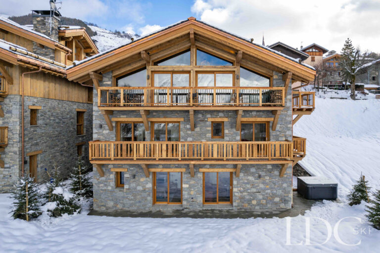 Chalet Constantia's impressive stone and timber exterior in the snow in St Martin de Belleville