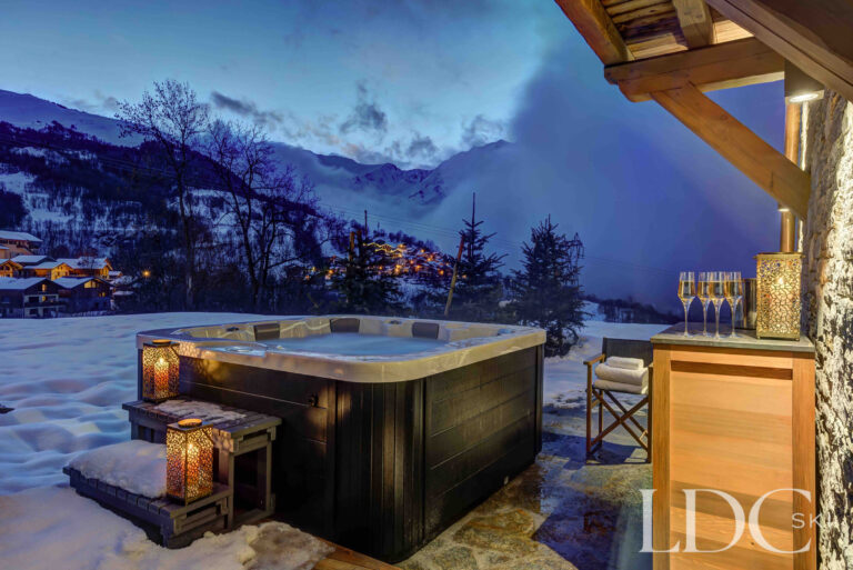 Private hot tub overlooking the mountains at dusk at Chalet Constantia