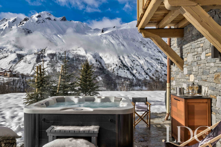 Private outdoor hot tub with dramatic mountain views at Chalet Constantia