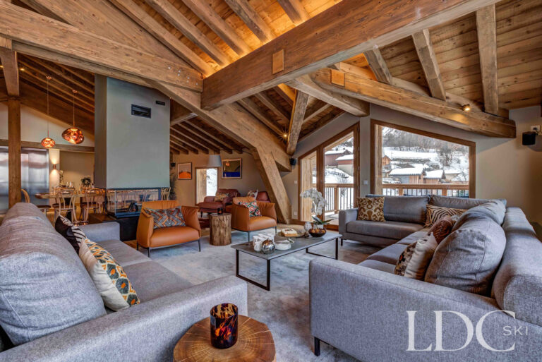 Spacious timber-beamed lounge with large windows overlooking the mountains at Chalet Constantia