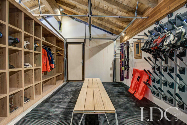 Large ski and boot room with extensive storage and heated boot racks at Chalet Constantia