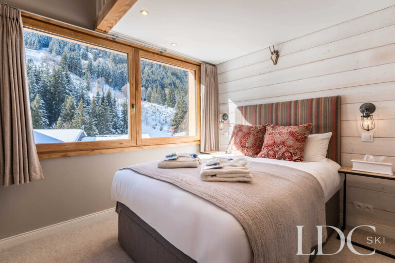Double bedroom with snowy views towards Tougnète at Chalet Quatre Meules in Méribel