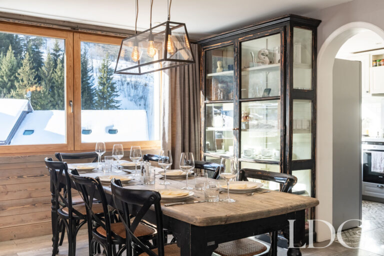 Dining area with large windows overlooking the snowy surroundings at Chalet Quatre Meules