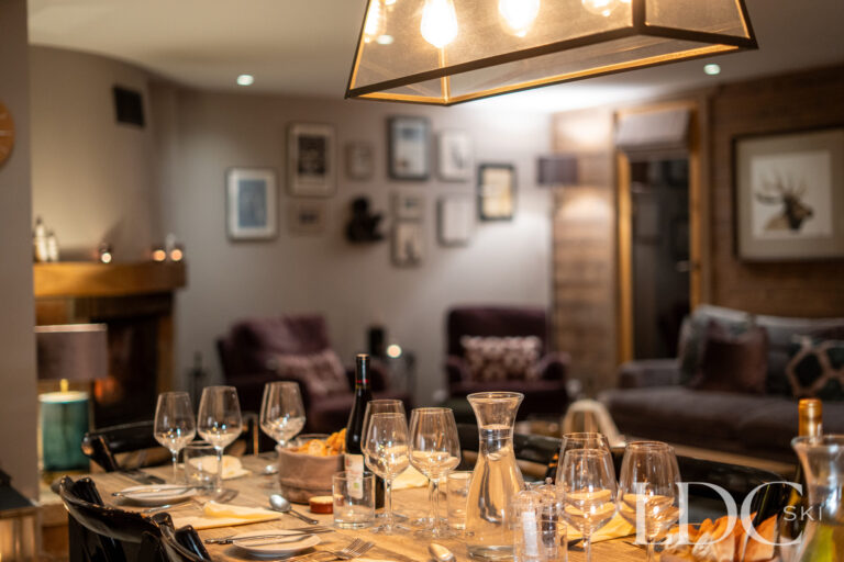 Dining table beautifully laid for an evening meal at catered Chalet Quatre Meules