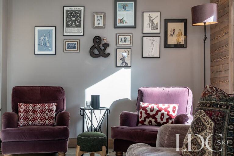 Armchairs and artwork adding character to the interior of Chalet Quatre Meules