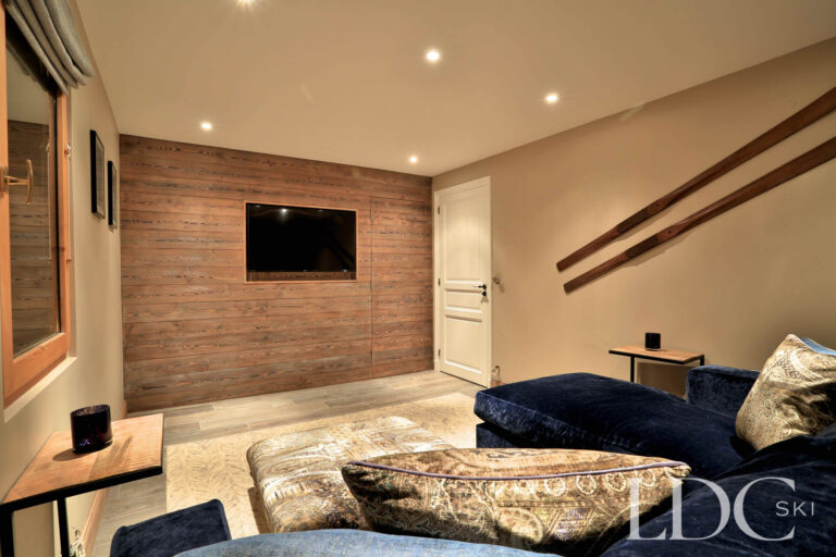 Separate cosy TV room with sofa seating at Chalet Quatre Meules