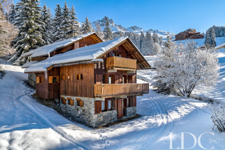 Traditional wooden exterior of Chalet Veronica surrounded by snow in Méribel