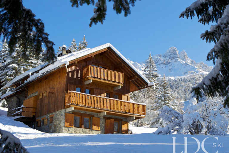Chalet Veronica in the snow with the Saulire mountains behind in Méribel