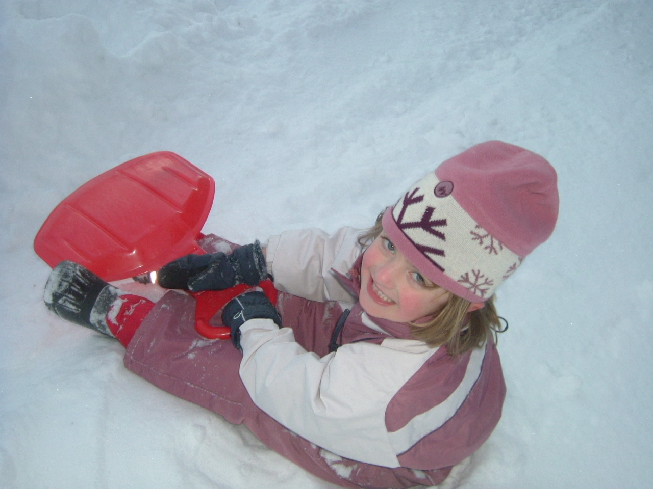 Child playing in the snow during a ski holiday
