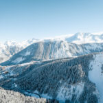Aerial winter view across Courchevel 1850 and the surrounding snow-covered mountains. © Courchevel Tourisme