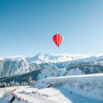 Hot air balloon above the snowy mountains and resort of Courchevel 1850. © Courchevel Tourisme