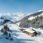 Aerial view across the snowy pistes and lifts of the Courchevel ski area. © Courchevel Tourisme