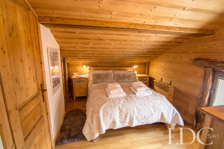 Double bedroom with sloping timber ceiling at Encombres Tête de Fer
