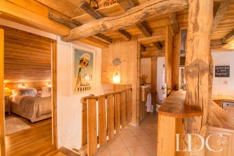 Characterful timber interior and hallway leading to a bedroom at Encombres Tête de Fer