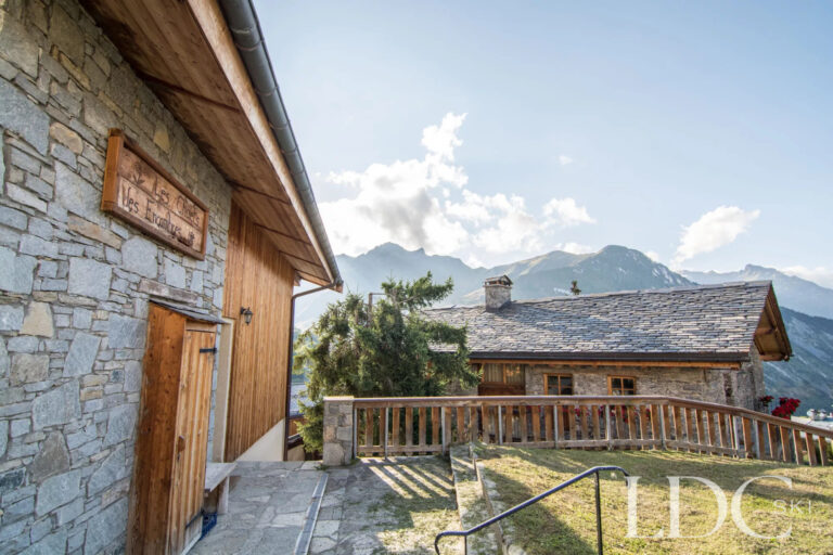 Terrace beside Encombres Tête de Fer with traditional chalet rooftops and mountain views